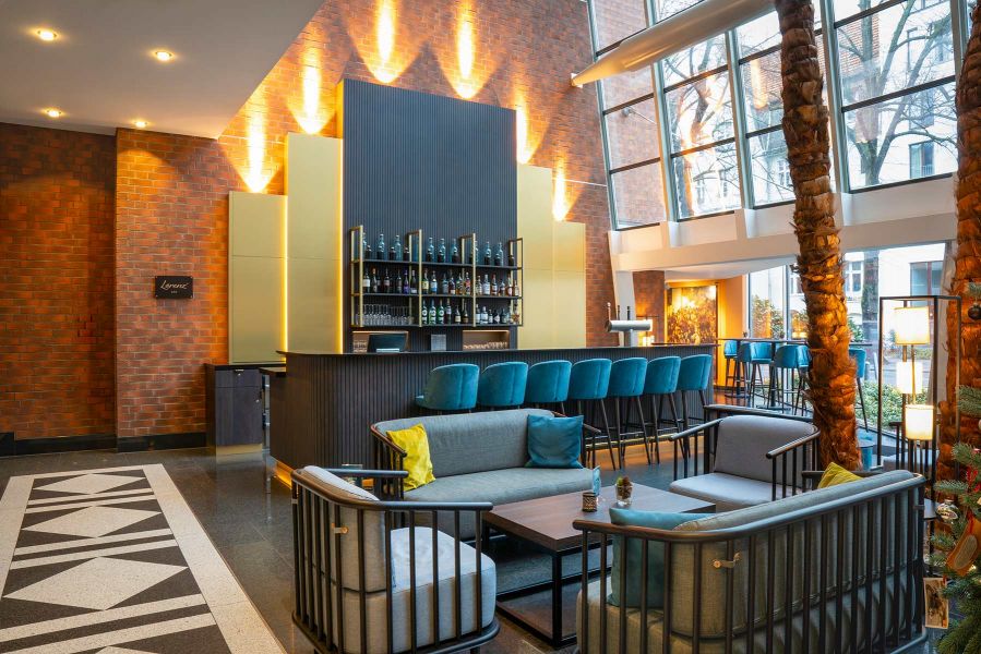 Sitzgruppen aus hellblauem Stoff mit dunklem Metallrahmen auf dunklem Boden