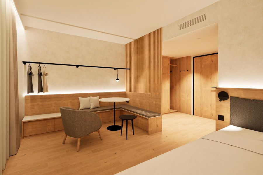 Rendering des Long-Stay-Apartments mit Sitzecke und Garderobe