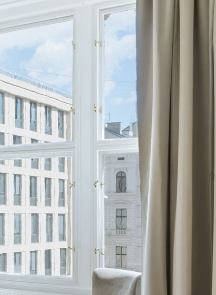 Perspektivischer Blick auf die Fensterfront mit Fokus auf den natürlichen Lichteinfall und die hochwertige Verarbeitung der Fensterrahmen und Wandabschlüsse