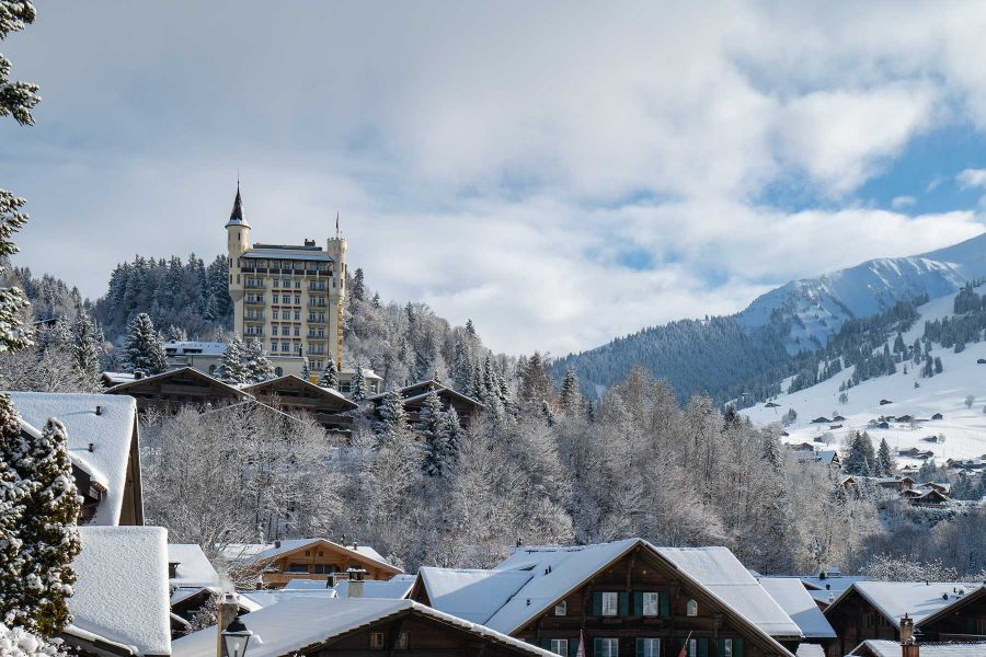 Außenansicht des Gstaad Palace Hotel in winterlicher Berglandschaft